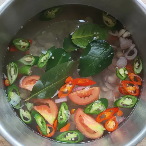 Masak air sampai mendidih, masukkan cabai, bawang merah, bawang putih, tomat, ale, daun salam, daun jeruk dan lengkuas. 
Masak selama 3 menit.