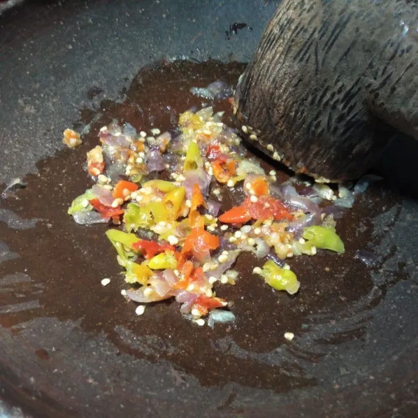 Ulek semua bahan sambal, tidak perlu halus biarkan masih kasar.