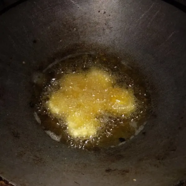 Panaskan minyak goreng, goreng adonan tahu hingga kuning kecokelatan.