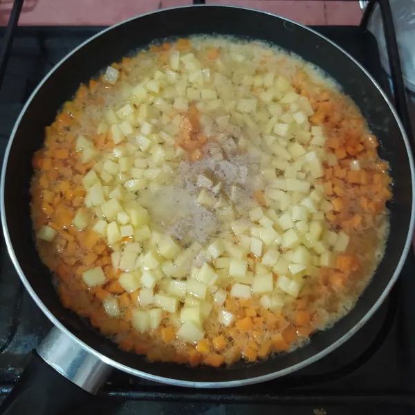 Tumis bumbu putih hingga harum lalu masukkan wortel dan kentang. 
Tambahkan garam, lada, kaldu ayam dan gula pasir lalu masak sampai mengental.