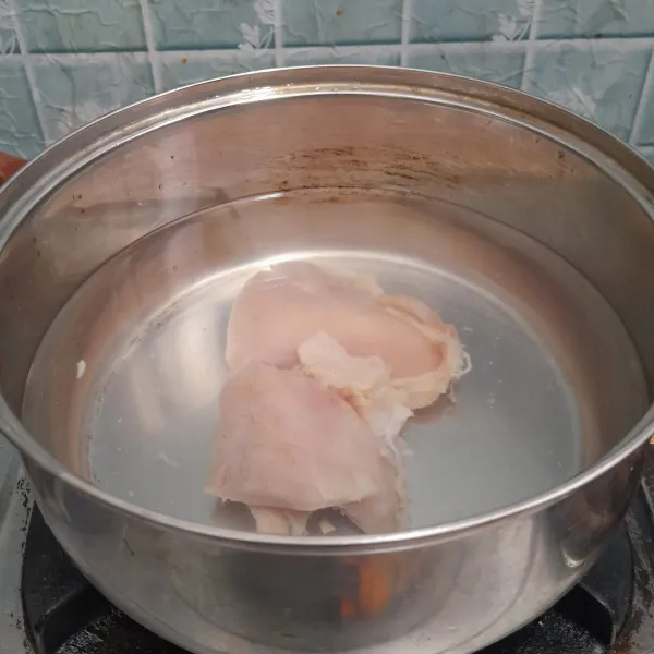 Didihkan air lalu masukkan daging ayam dan masak hingga lunak.