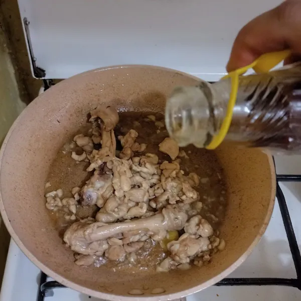 Tambahkan minyak wijen, aduk cepat, angkat ayam dan sisihkan minyaknya.