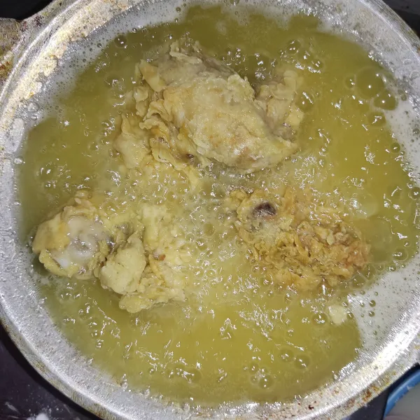 Panaskan minyak dengan api besar. Goreng ayam hingga ayam terendam minyak. Goreng hingga kuning kecoklatan.