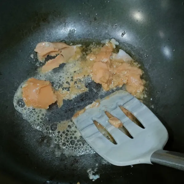 Panaskan minyak, kemudian masukkan kuning telur asin, sambil dihancur-hancurkan, lalu masak hingga berbuih.