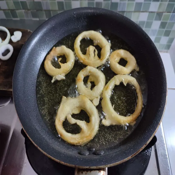 Masak hingga matang merata dan onion ring berwarna golden brown, angkat, kemudian tiriskan minyaknya. 
Setelah itu sajikan di atas piring saji.