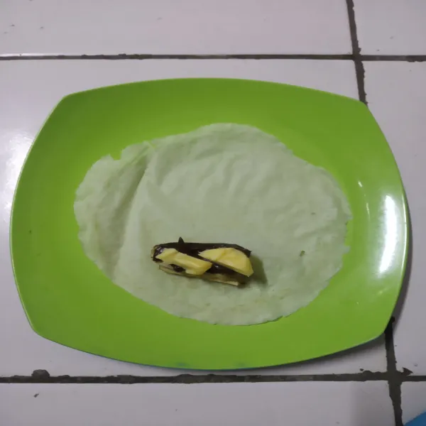 Siapkan kulit lumpia, taruh pisang di atasnya, selai cokelat dan terakhir keju mozzarella.