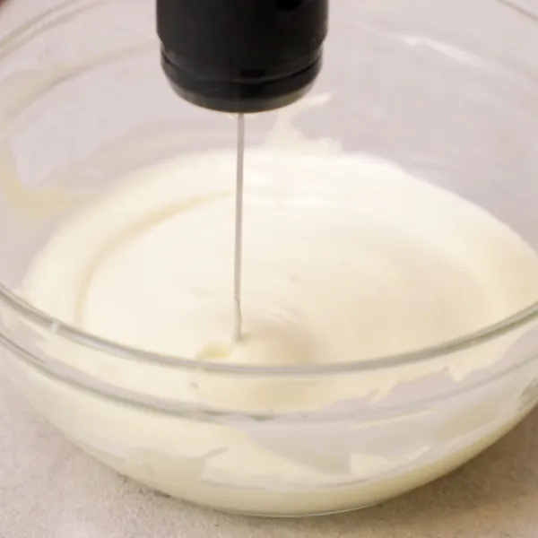 Tuangkan whipped cream ke dalam wadah, mixer sebentar hingga sedikit mengental, sisihkan.