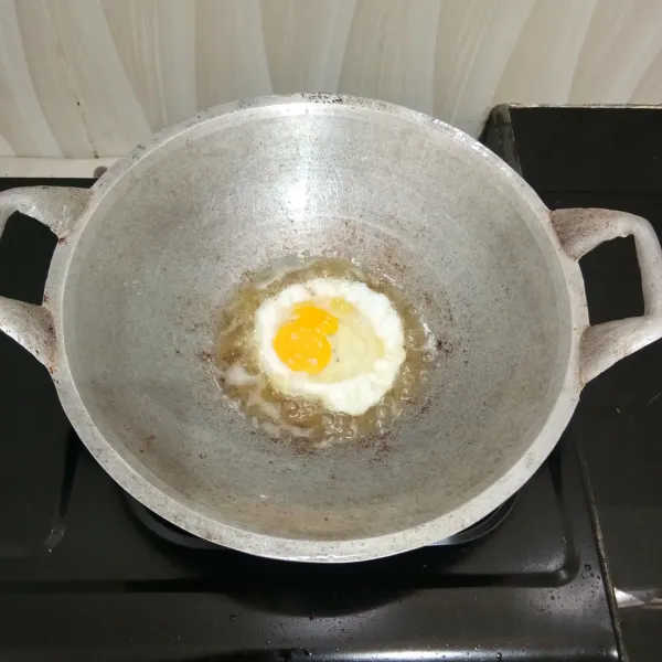 Panaskan minyak goreng. Ceplok telur satu per satu hingga matang. Sisihkan.