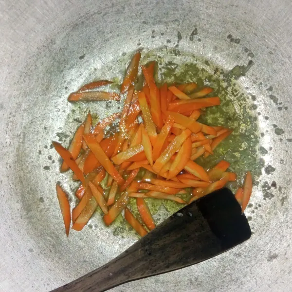 Masukkan wortel ke dalam tumisan bawang, lalu tuang air. Masak hingga wortel setengah matang.