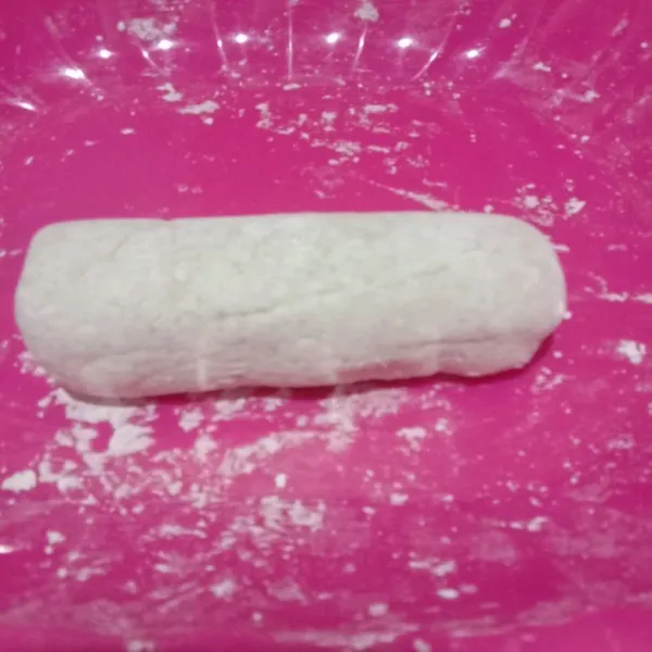 Siapkan alas datar dan bersih.
Ambil segenggam adonan, ratakan betuk bulatan sebentar saja lalu giling di atas alas pelan-pelan hingga membetuk bulat panjang.