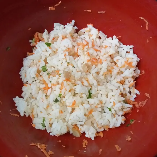 Campur nasi, keju parut, wortel, sosis, seledri, dan kaldu ayam bubuk, kemudian aduk rata sambil sedikit diremas-remas.