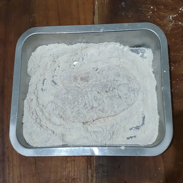 Baluri seluruh permukaan ikan dengan adonan tepung kering.