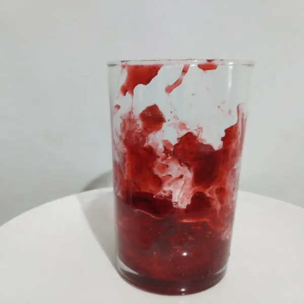 Masukkan selai strawberry ke dalam gelas dan oleskan selai disekeliling gelasnya.