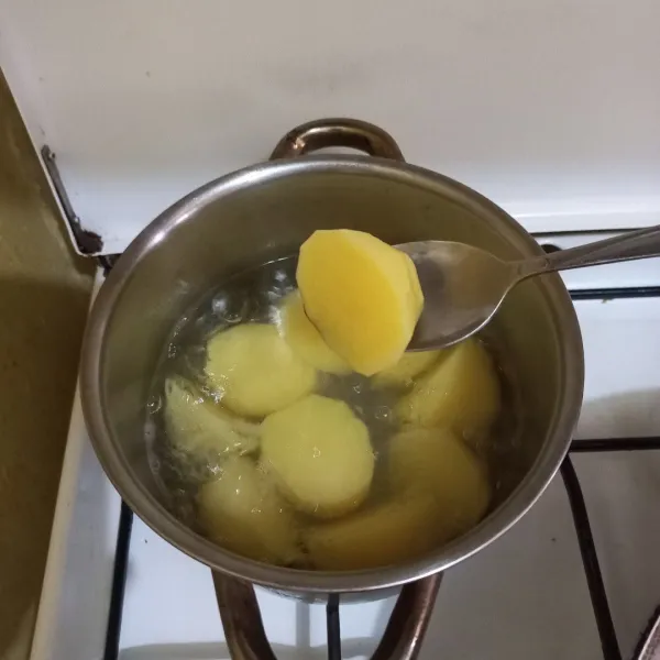 Rebus kentang hingga empuk, kemudian tiriskan.