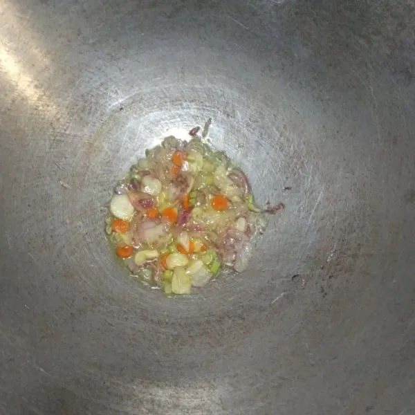 Tumis bawang merah, bawang putih, serai, lengkuas, dan kunyit hingga harum.