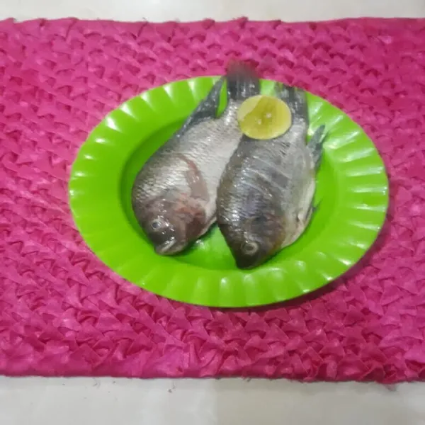 Bersihkan ikan nila, lumuri dengan air jeruk nipis dan diamkan sebentar lalu bilas.