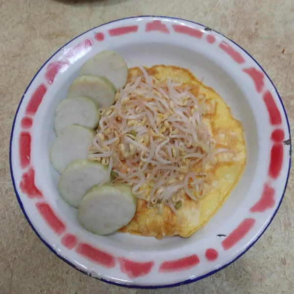 Tata di dalam piring, tahu telur dadar, irisan lontong, kecambah yang sebelumnya sudah direbus. Lalu siram dengan sambel kacang, tambahkan irisan seledri, beri taburan bawang goreng, kerupuk dan acar timun. Sajikan.