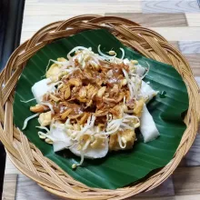 Siapkan piring saji. Tata potongan lontong, potongan tahu goreng dan tauge. Lalu siram dengan bumbu. Beri taburan bawang goreng. Sajikan.