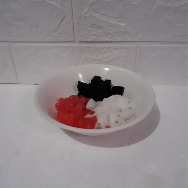 Masukkan sagu mutiara, cincau dan daging kelapa muda ke dalam mangkok.
