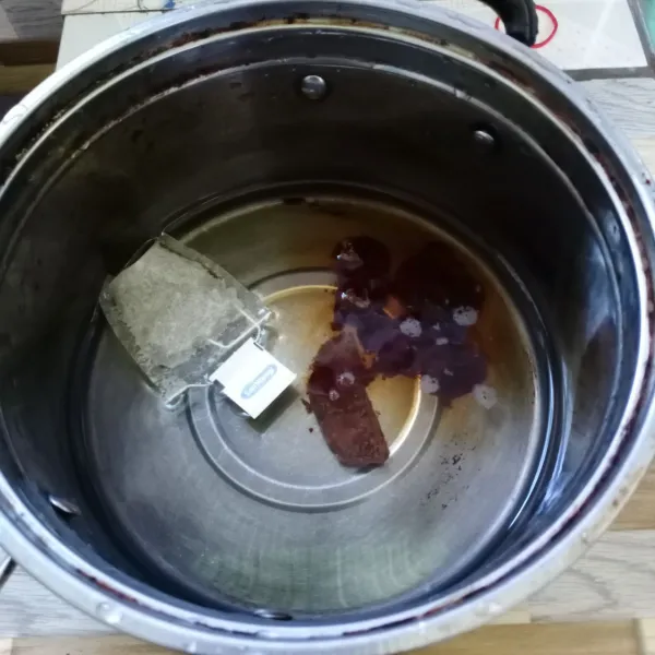 Dalam panci masukkan air, teh celup, asam Jawa dan gula merah.