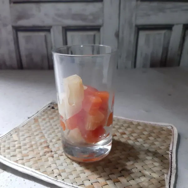 Tata setup pepaya nanas yang sudah dingin ke dalam gelas.