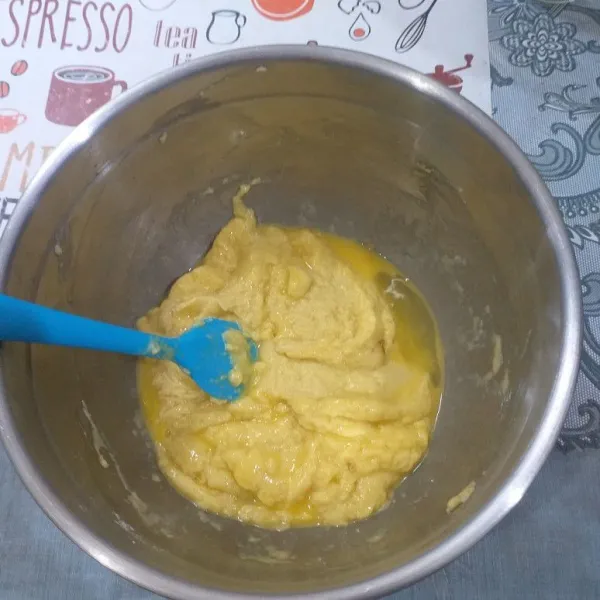 Tuang air dan mentega ke dalam terigu yang telah di campur vanili, aduk dan tambahkan telur.