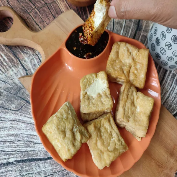 Tata tahu goreng di dalam piring saji, lalu sajikan dengan sambal kecap.