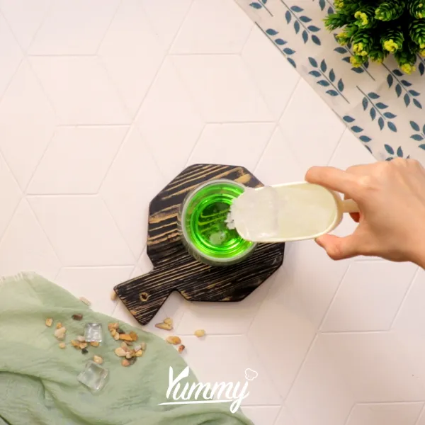 Tambahkan es batu hingga ¾ tinggi gelas dan tambahkan irisan lemon.