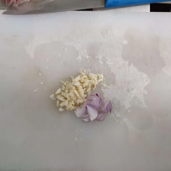 Cincang kasar bawang putih, lalu iris bawang merah dan sisihkan.