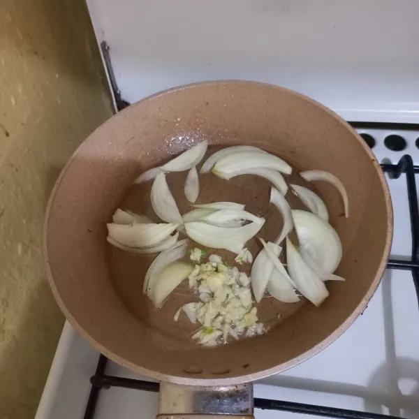 Panaskan minyak goreng, tumis irisan bawang putih dan bawang bombay hingga harum.