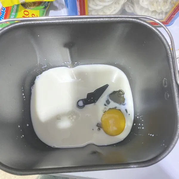 Masukkan bahan cair, yakni telur dan susu cair.