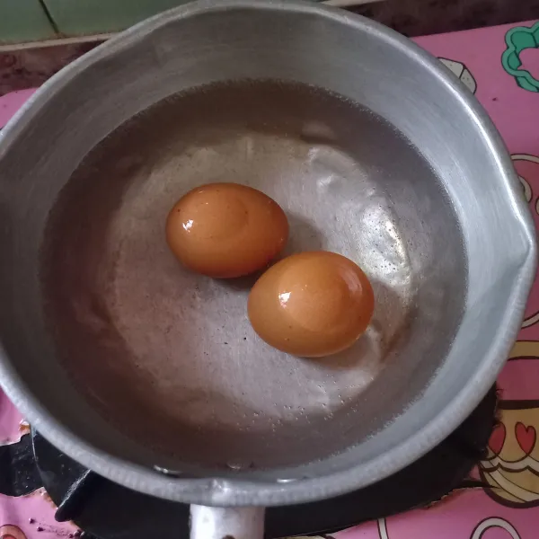 Rebus telur hingga matang, sambil menunggu telur matang siapkan bumbu, cincang halus bawang bombai, sisihkan.