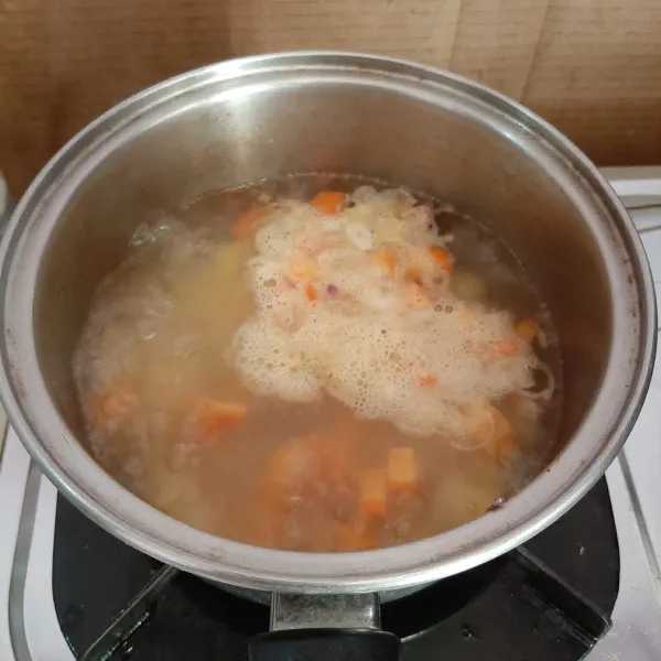 Masukkan wortel. Lalu kentang. Bumbui dengan garam, kaldu bubuk, merica bubuk dan kecap manis. Masak hingga sayuran empuk.