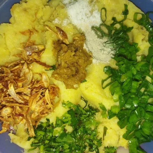 Lalu haluskan kentang yang sudah di goreng, tambahkan bumbu yang tadi sudah di haluskan, daun bawang, daun seledri, bawang goreng, garam, kaldu bubuk, dan lada bubuk, kemudian aduk hingga semua bahan tercampur rata.