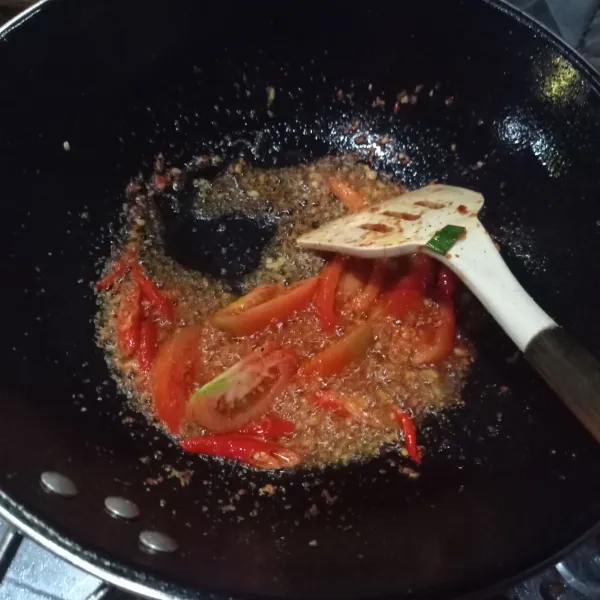 Tumis bumbu halus, tomat dan irisan cabe sampai bumbu matang.
