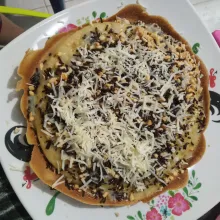 Pindahkan ke piring, oles dengan margarin dan 1 sdm kental manis. Tambahkan kacang tanah cincang, meises coklat dan keju parut lalu tuang kental manis putih.
