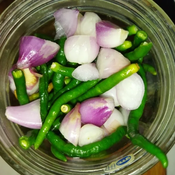 Haluskan cabe merah keriting dan bawang merah.