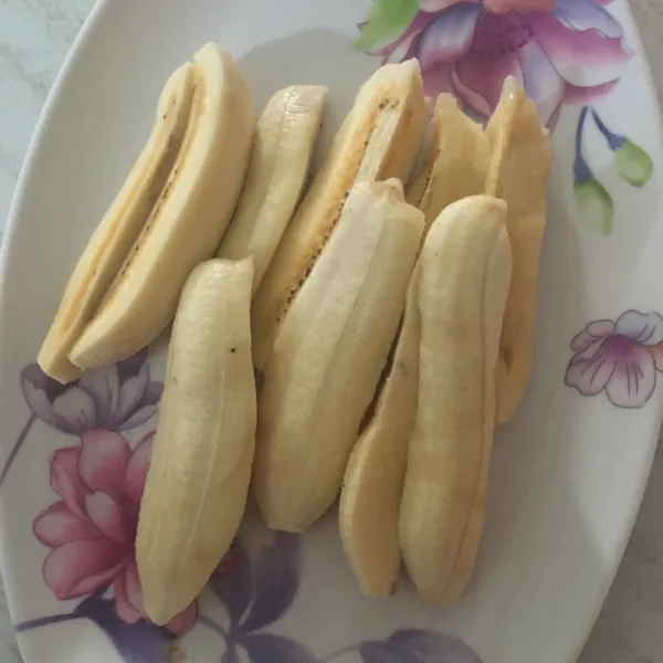 Potong-potong pisang kepok secara memanjang.