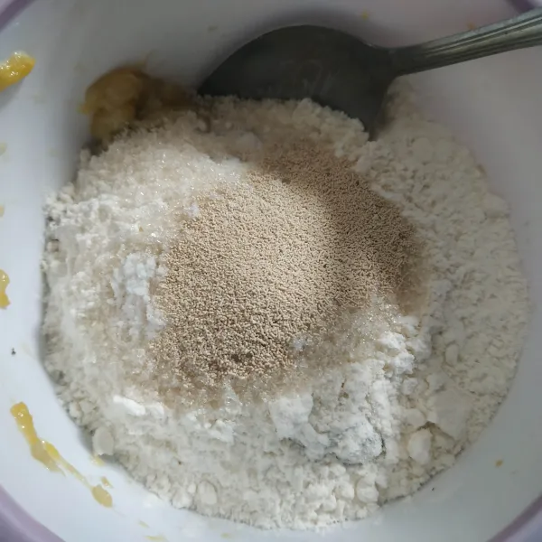 Campur pisang dengan tepung terigu, garam, gula dan ragi instan, aduk hingga adonan tercampur rata.