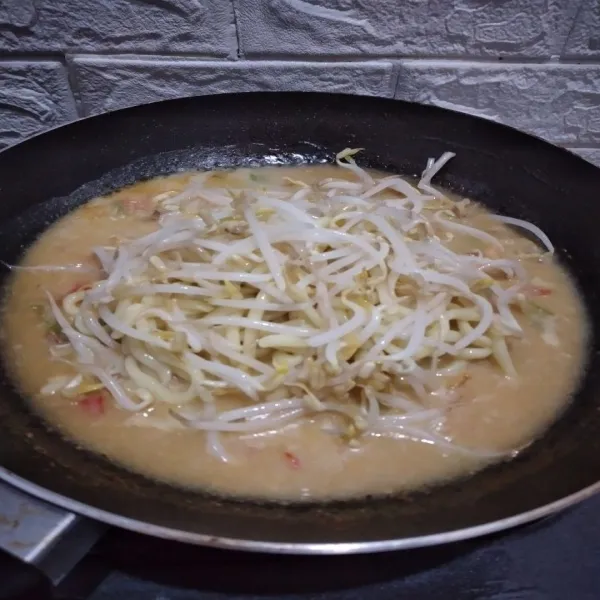 Tambahkan tauge yang sudah direndam air panas, sajikan mie kuah tauge dengan taburan bawang goreng.