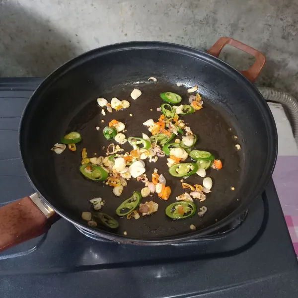 Masukkan irisan cabai dan masak sampai layu.