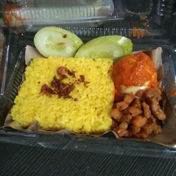 Nasi kuning siap disajikan dengan menu lainnya.