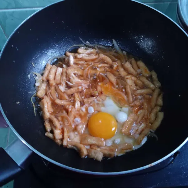 Masukkan telur, aduk-aduk dan masak hingga air menyusut/habis. Koreksi rasa dan selesai. Sajikan dengan taburan cabai merah besar goreng.