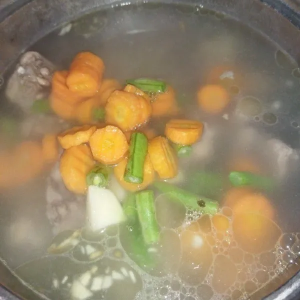 Masukkan potongan wortel, kentang dan buncis, rebus hingga sayuran setengah matang.
