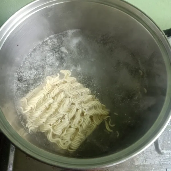 Siapkan panci lalu isi air. Lalu rebus mie sampai matang.