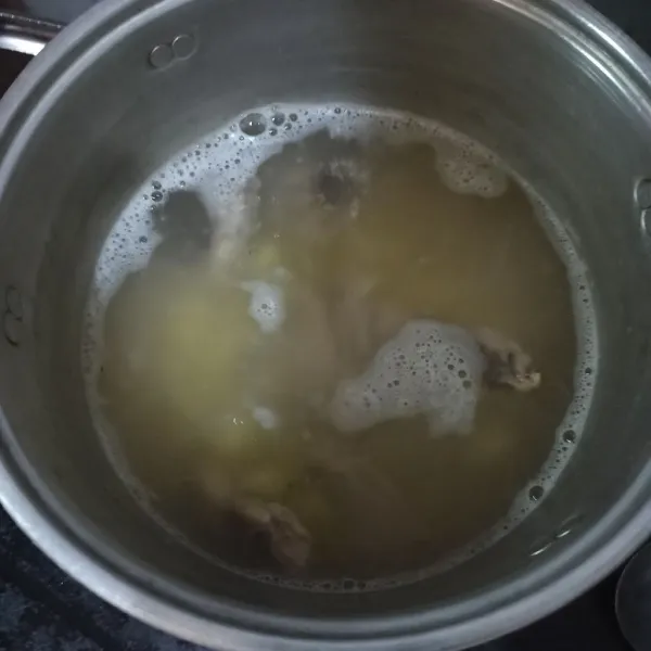 Ketika air mendidih. Masukkan bawang putih goreng yang sudah dihaluskan, tulangan ayam dan kentang. Tunggu hingga kentang matang. Beri kaldu bubuk.