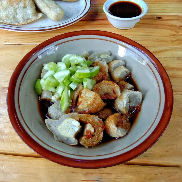 Sajikan pempek dengan dengan cuko dan Potongan mentimun.