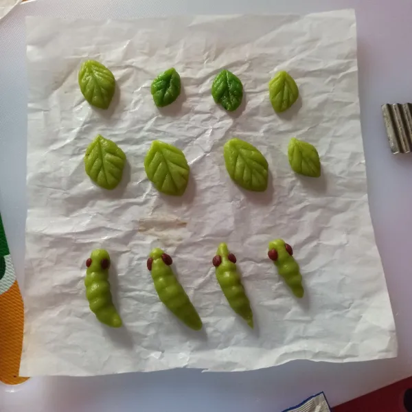 Kemudian bagian ujungnya buat bulatan cokelat untuk matanya. Sebagian saya buat daun juga. Nah kemudian letakkan di kertas roti yang sudah dioles margarin.