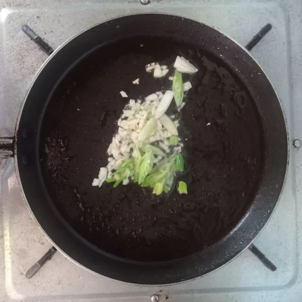 Panaskan minyak, tumis bawang putih dan bawang daun (ambil bagian putihnya) hingga wangi.