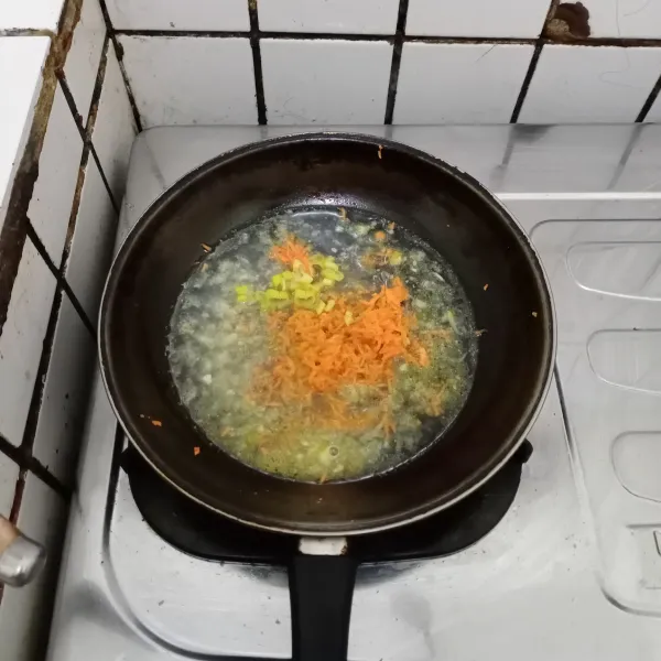 Masukkan wortel & daun bawang. Tambahkan air. Aduk rata